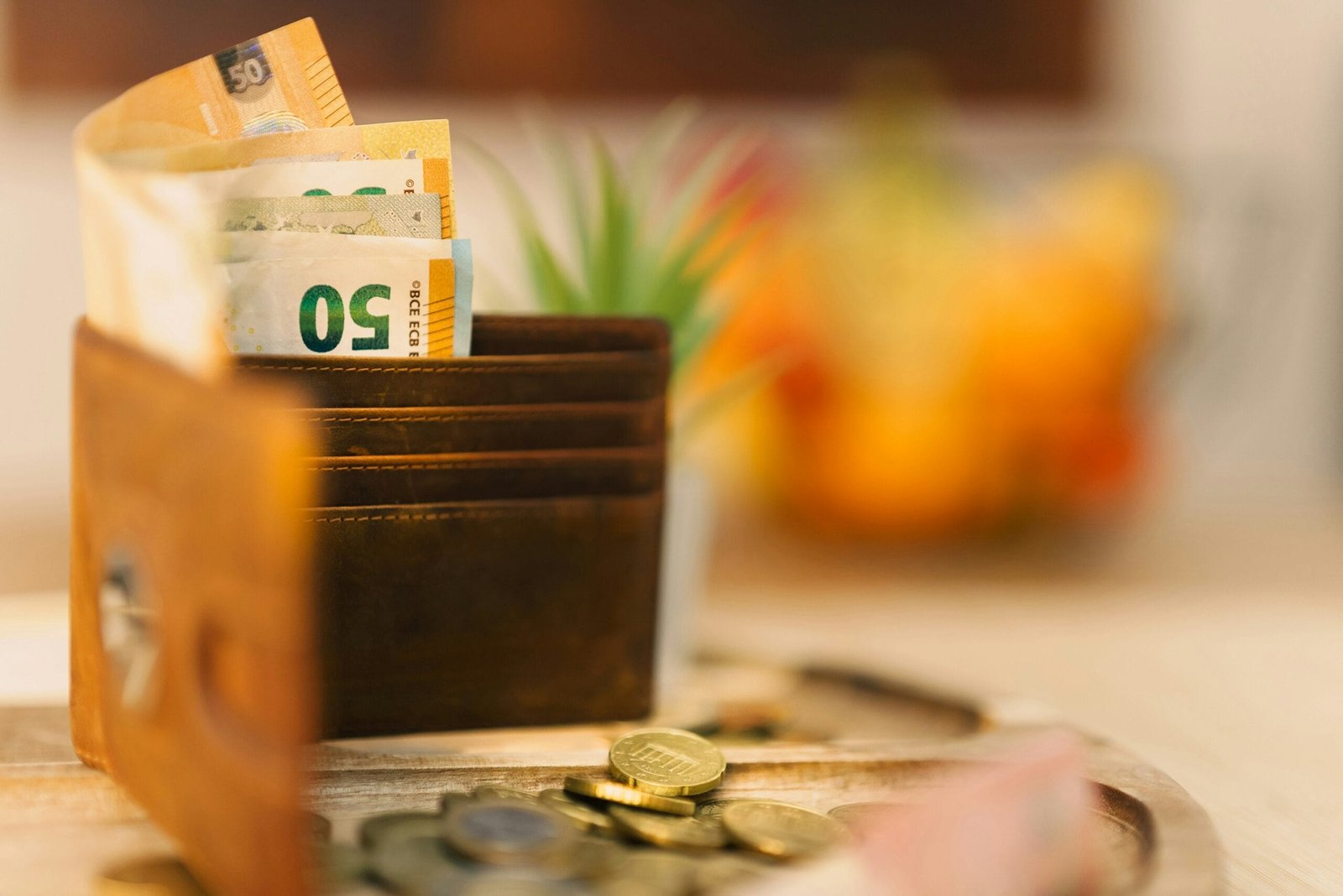 A wallet sitting on top of a table filled with money